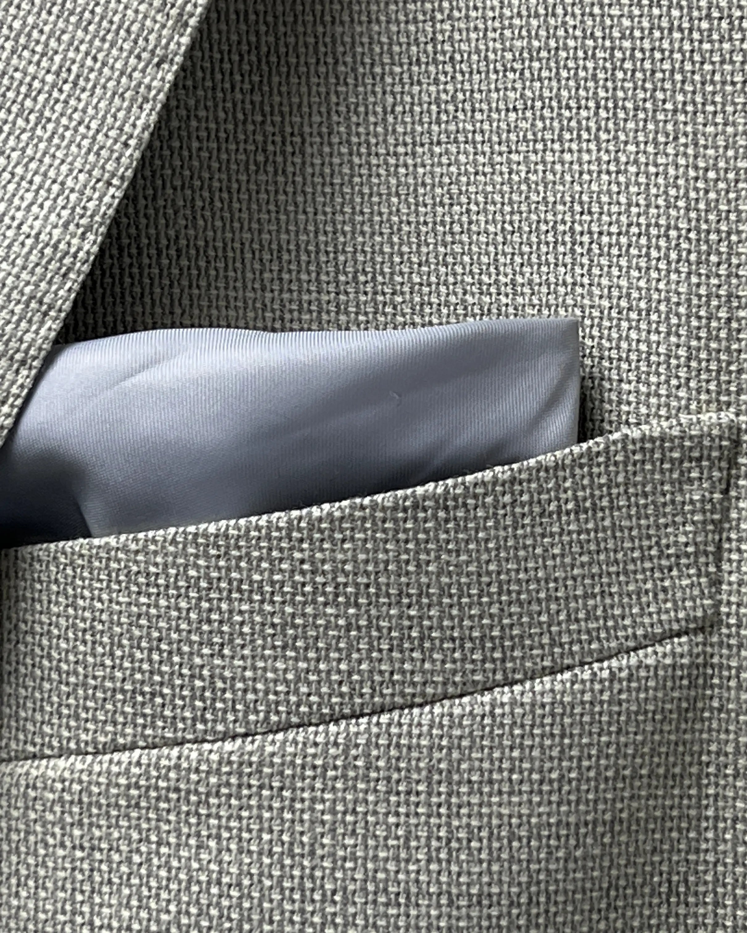 Pocket square detail of light tan hopsack men's sport coat showing the built in lining pocket square