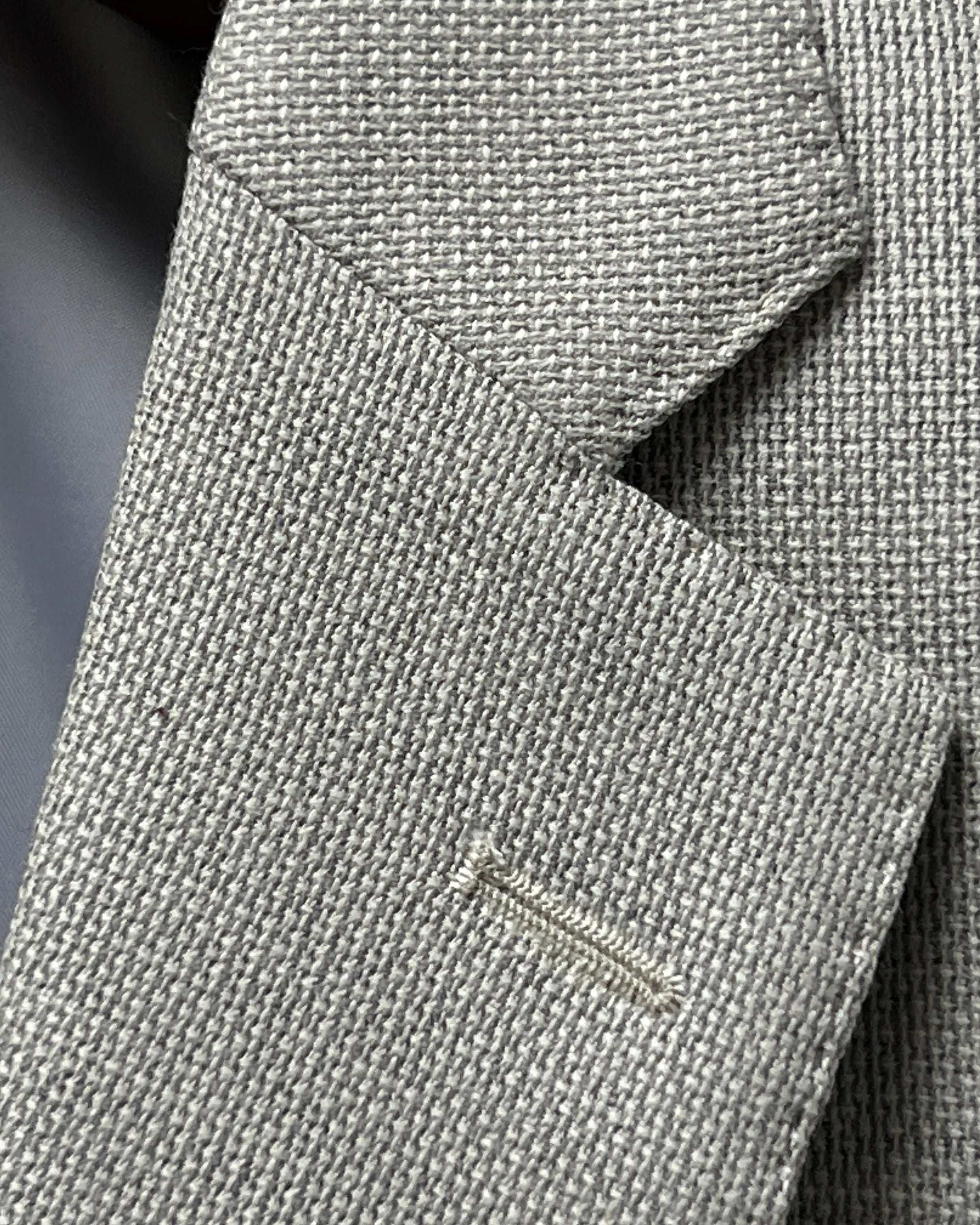 Lapel buttonhole detail of light tan hopsack men's sport coat showing the standard lapel buttonhole stitching