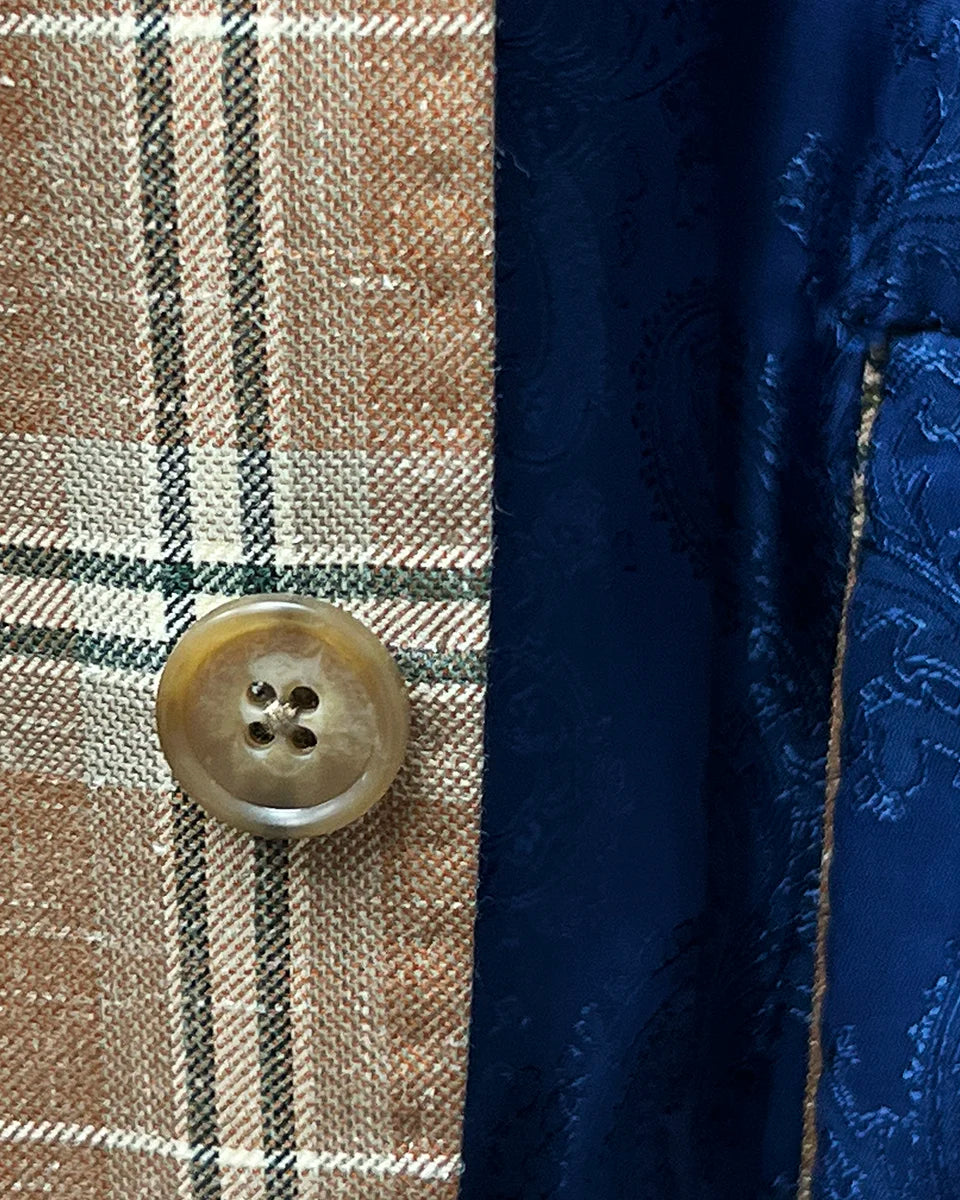 Horn marble buttons adding a classic touch to a brown beige men's sport coat with blanched almond and midnight blue windowpane pattern.