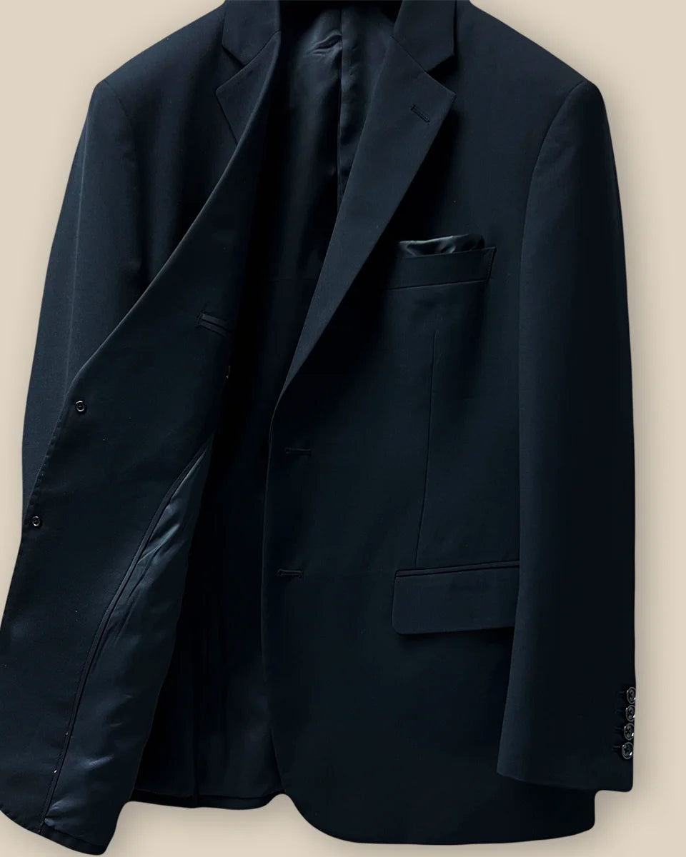 Inside view of the right side of a classic black men's suit showcasing inner craftsmanship.