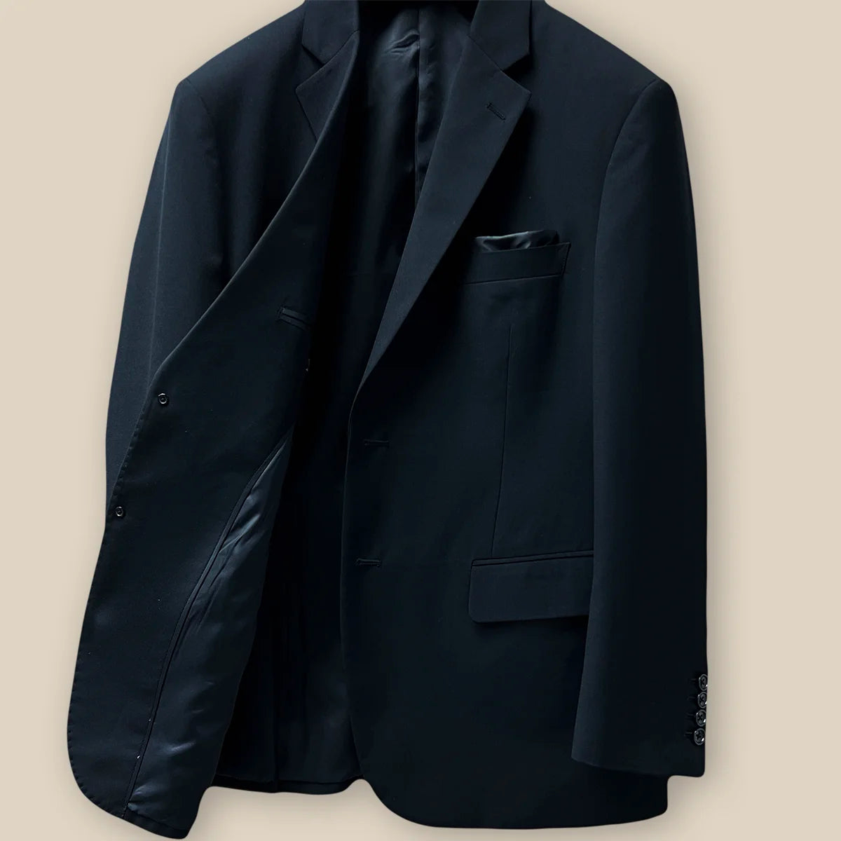 Inside view of the right side of a classic black men's suit showcasing inner craftsmanship.