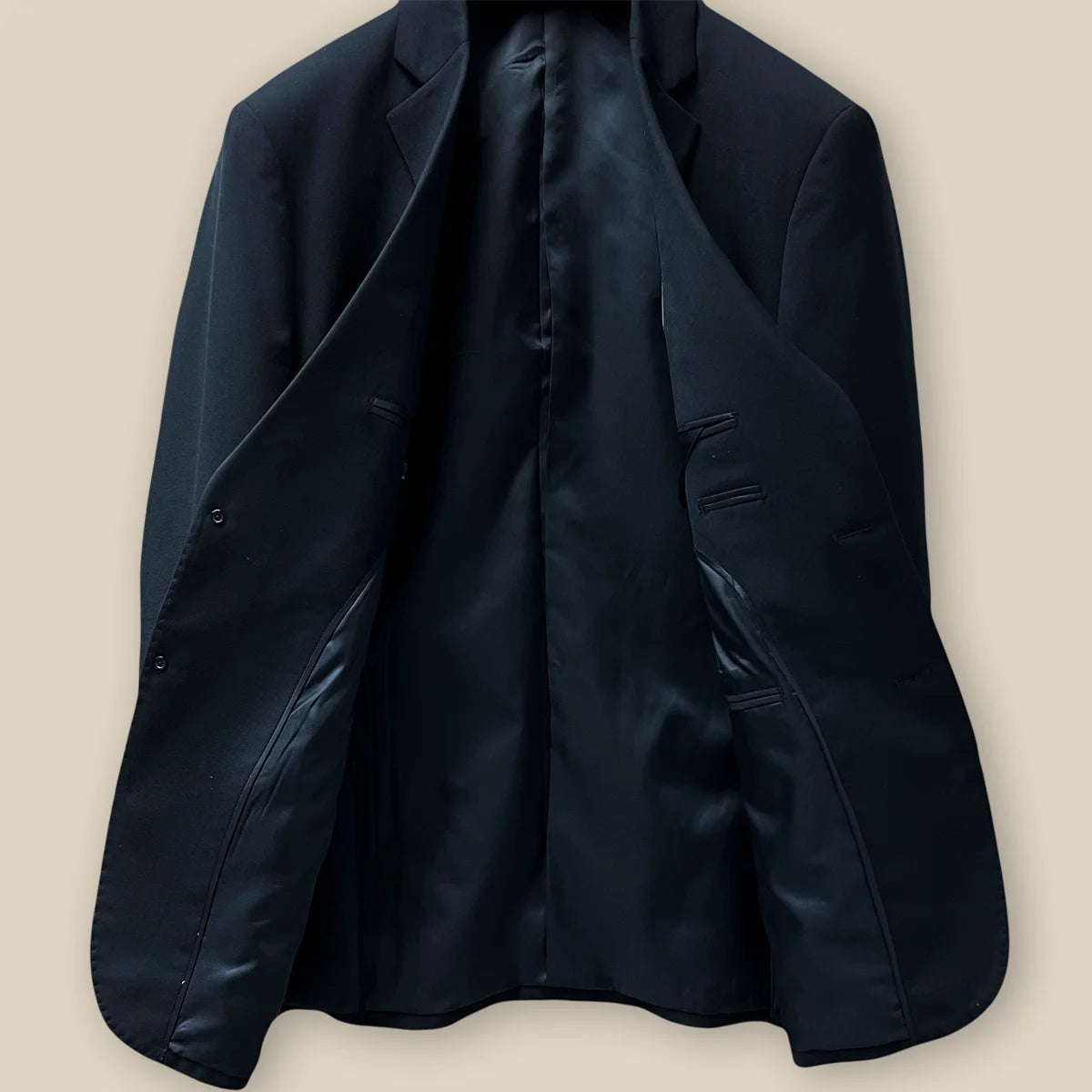 Inside view showcasing the lining and craftsmanship of a classic black men's suit.