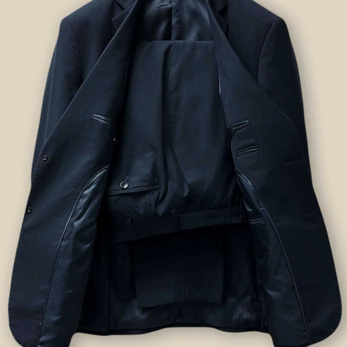 Full view of a coordinated classic black men's suit showcasing a formal look.