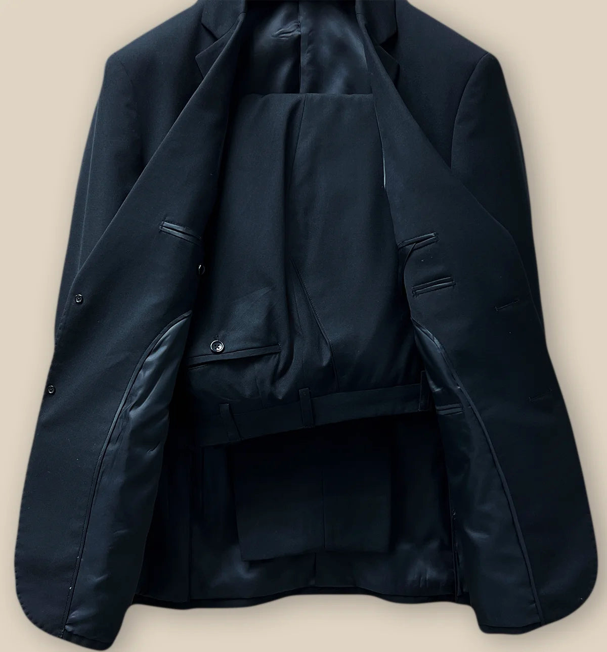 Full view of a coordinated classic black men's suit showcasing a formal look.