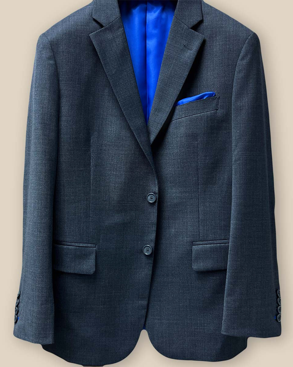 Detailed view of the button panel showcasing the button arrangement on a dark grey birdseye suit.