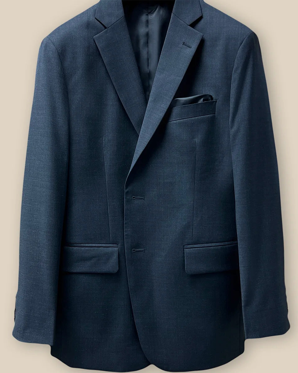 View of the buttonhole panel demonstrating the detailed work on a dark gray sharkskin suit.