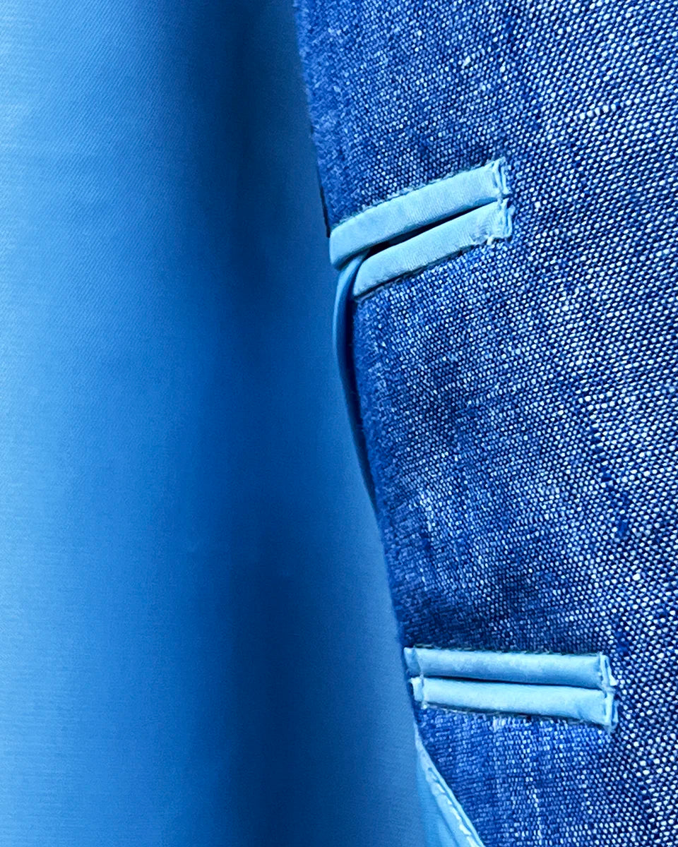 Close-up of sky blue bemberg silk lining texture and sheen in light blue solid Irish linen men's suit jacket