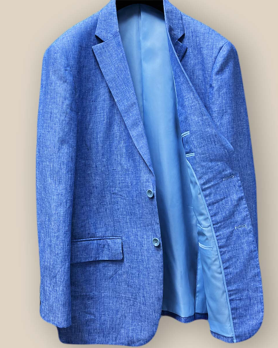 Interior view of light blue solid Irish linen men's suit jacket, showcasing sky blue bemberg silk lining on the right side