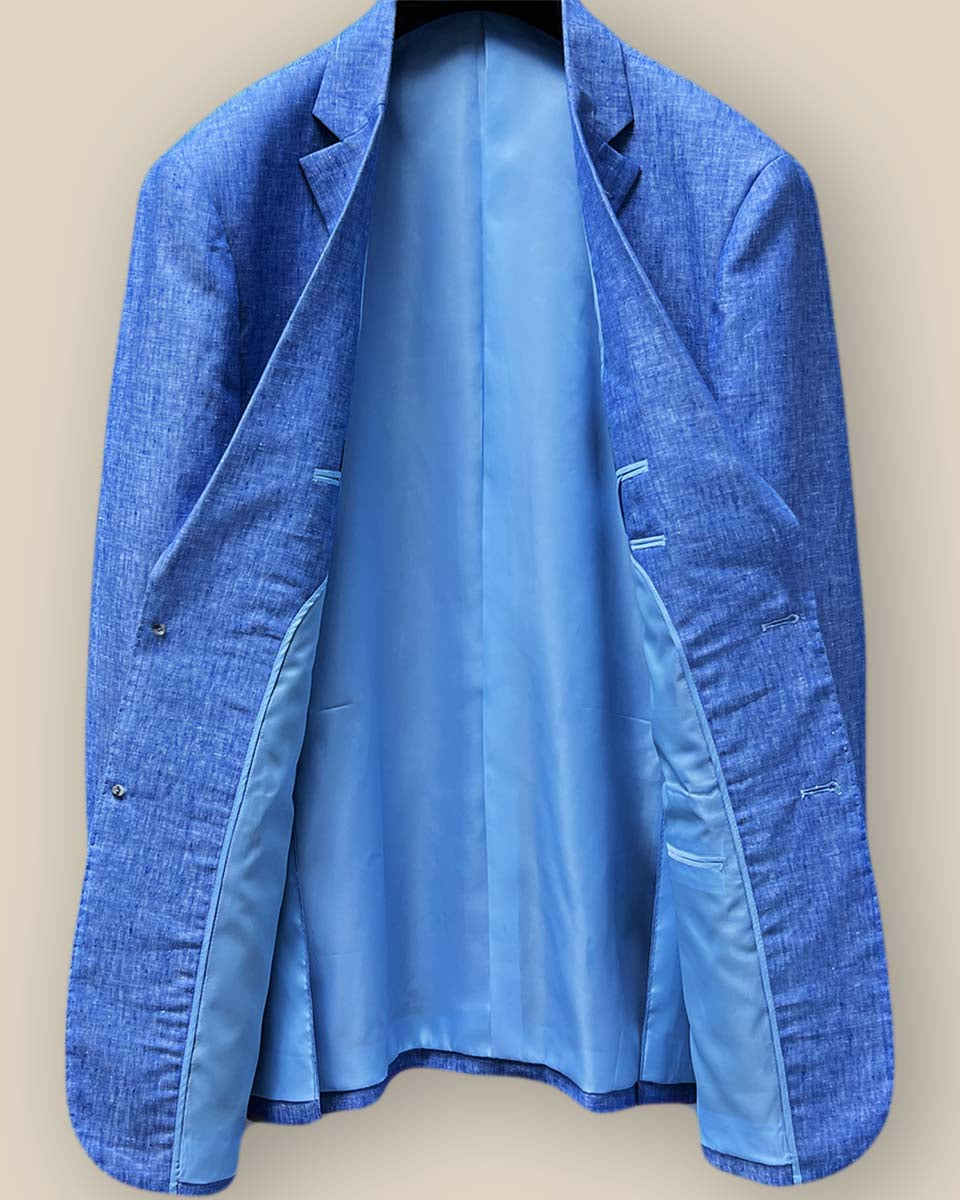 Full interior view of light blue solid Irish linen men's suit jacket, displaying sky blue bemberg silk lining