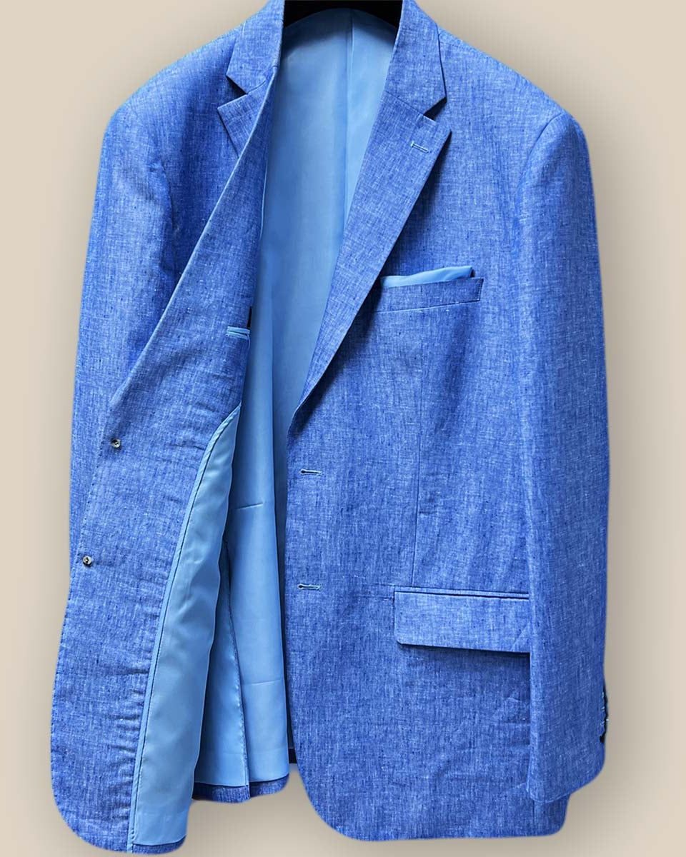 Interior view of light blue solid Irish linen men's suit jacket, showcasing sky blue bemberg silk lining on the left side