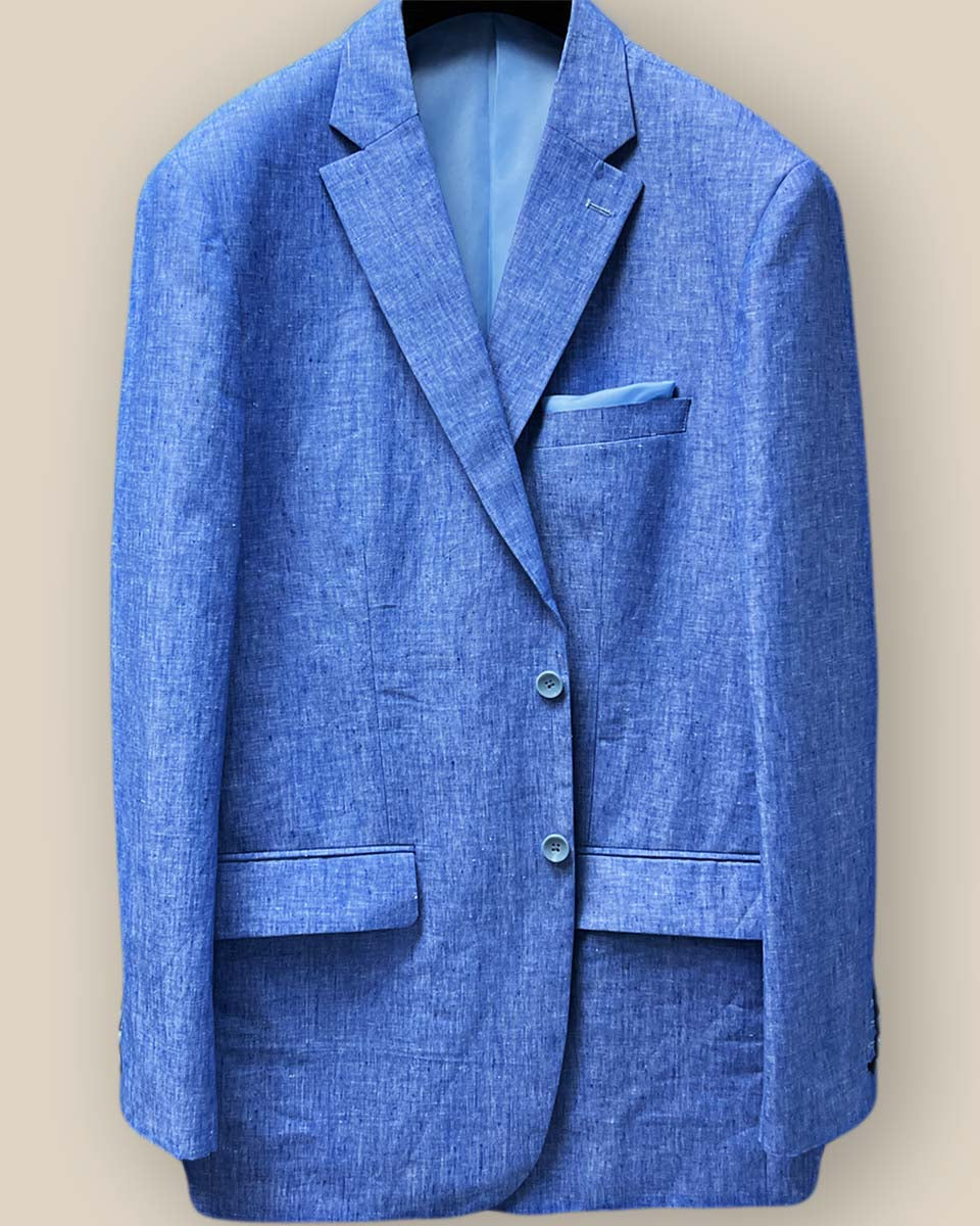 Close-up of light blue solid Irish linen men's suit jacket front, focusing on blue horn buttons and buttonholes