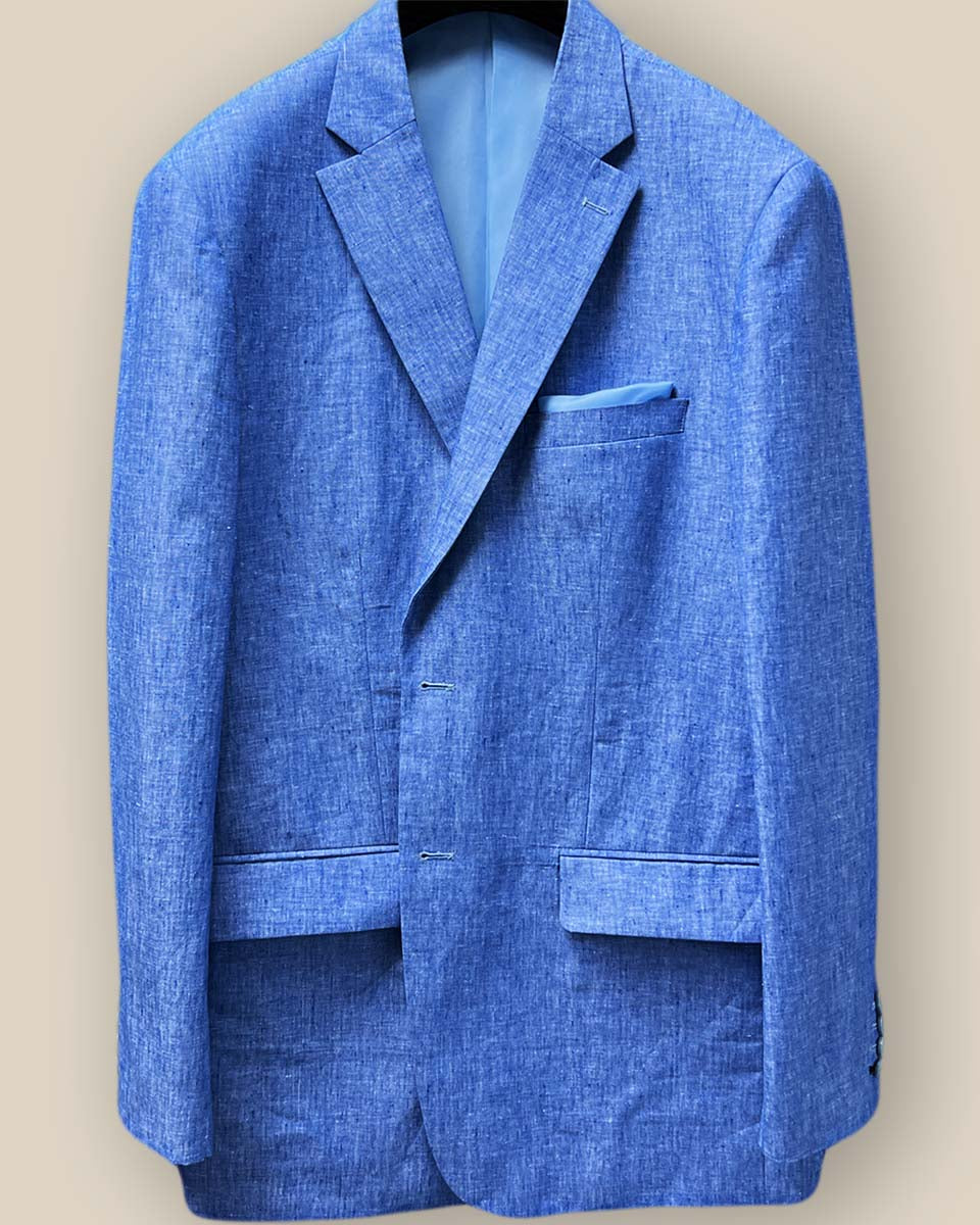 Close-up of light blue solid Irish linen men's suit jacket showing blue horn buttons and buttonholes