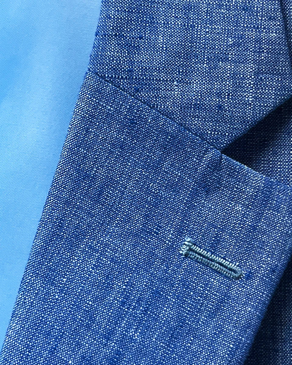 Detail shot of notch lapel on light blue solid Irish linen men's suit jacket