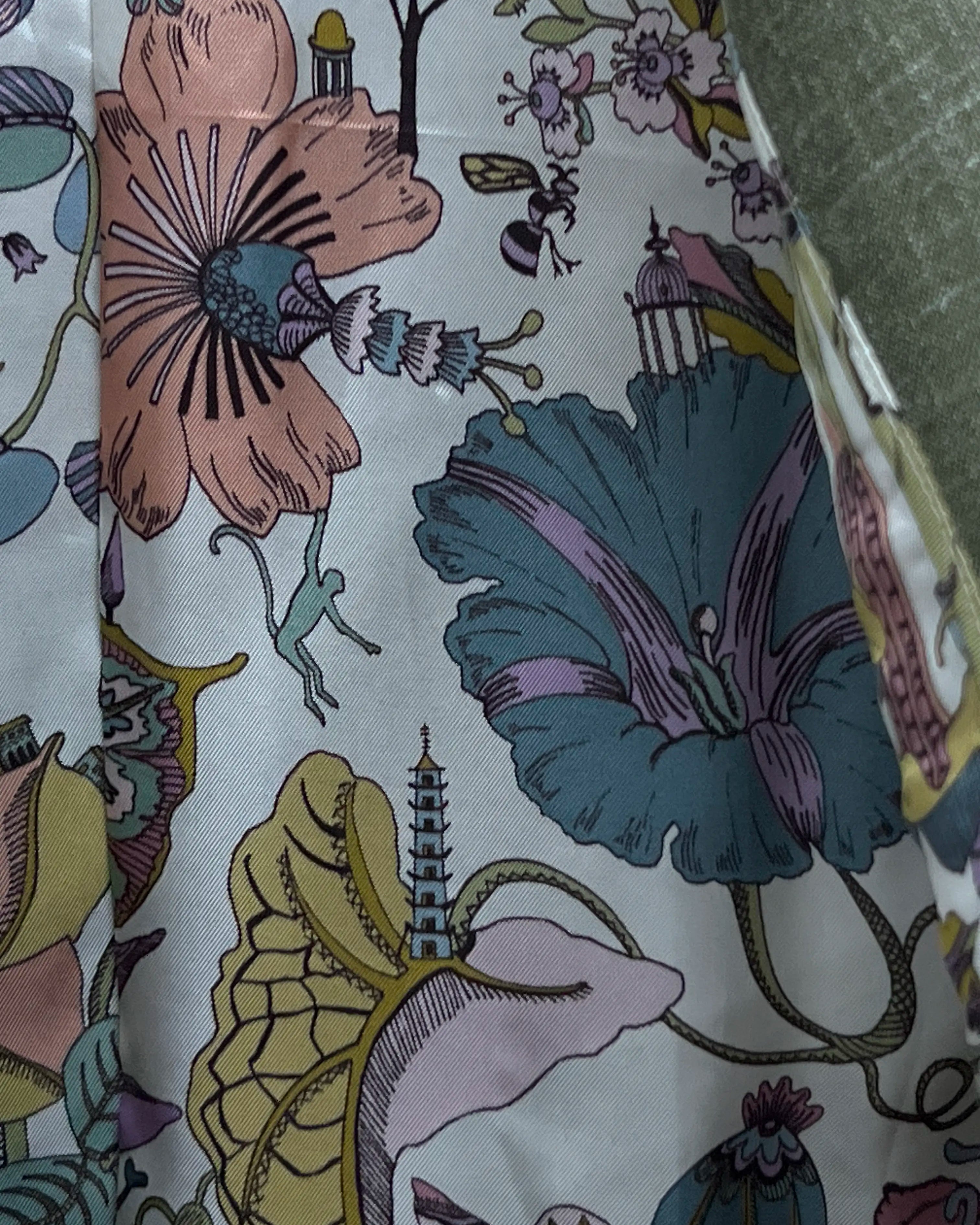 Interior lining of sage green plain men's suit showing botanical chinoiserie illustration print lining