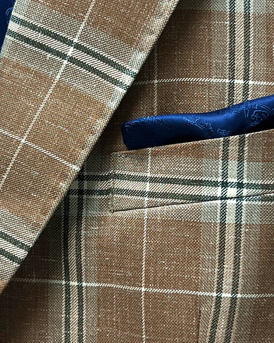 Pocket square adding elegance to a brown beige men's sport coat with blanched almond and midnight blue windowpane pattern.