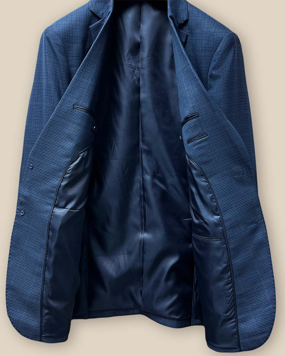 Full inside view of the prussian blue suit jacket, featuring the luxurious dark blue bemberg plain lining.