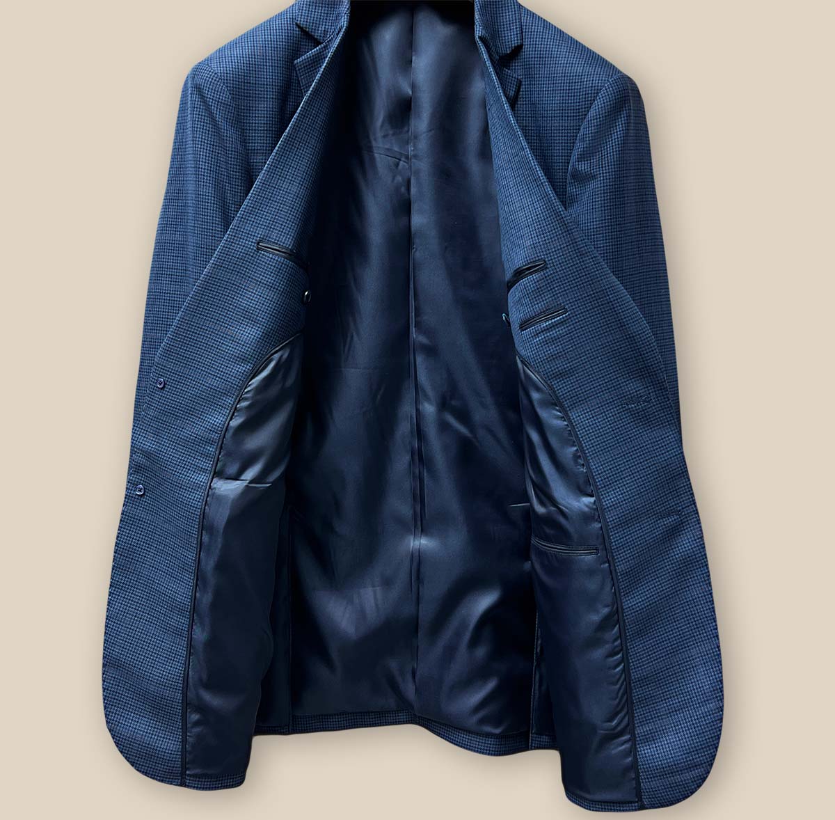 Full inside view of the prussian blue suit jacket, featuring the luxurious dark blue bemberg plain lining.