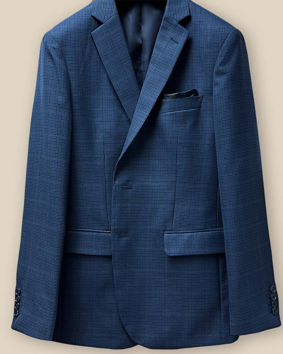 Close-up view of the prussian blue suit jacket buttonhole panel, showcasing the detailed stitching and navy marble horn buttons.