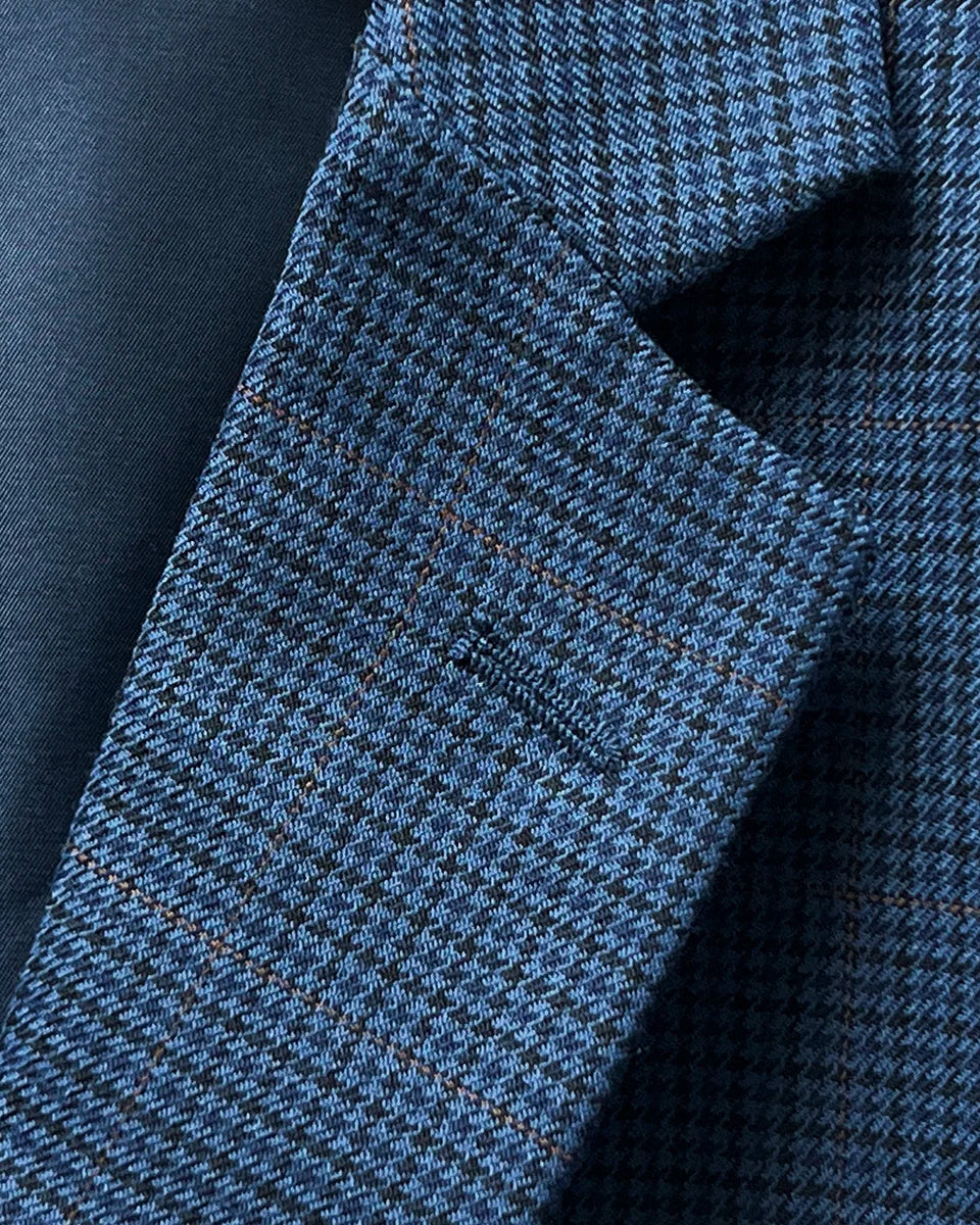 Detailed view of the notch lapel on the prussian blue suit jacket, featuring meticulous tailoring and a sharp finish.