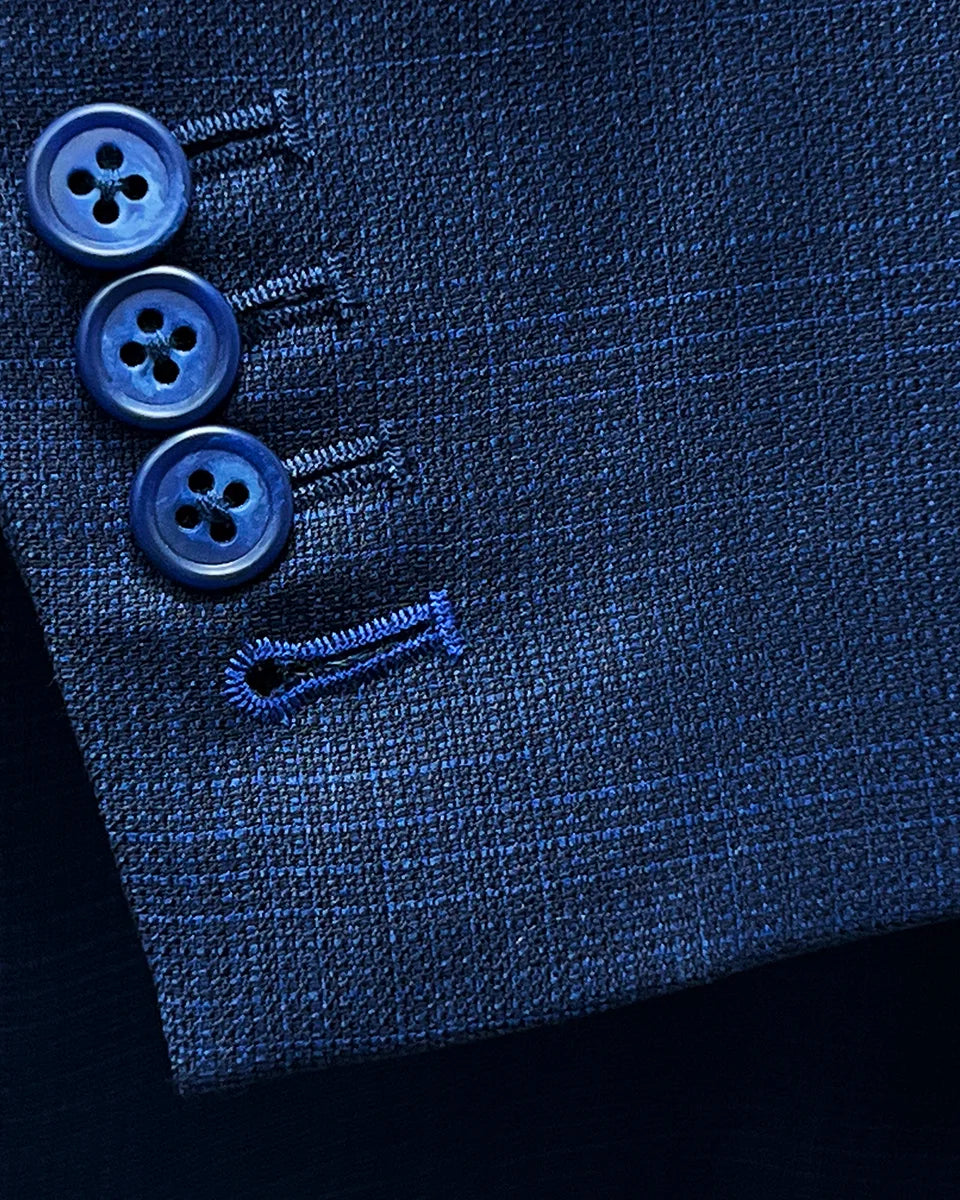 Close-up of the functional sleeve buttonholes with royal blue contrast stitching.
