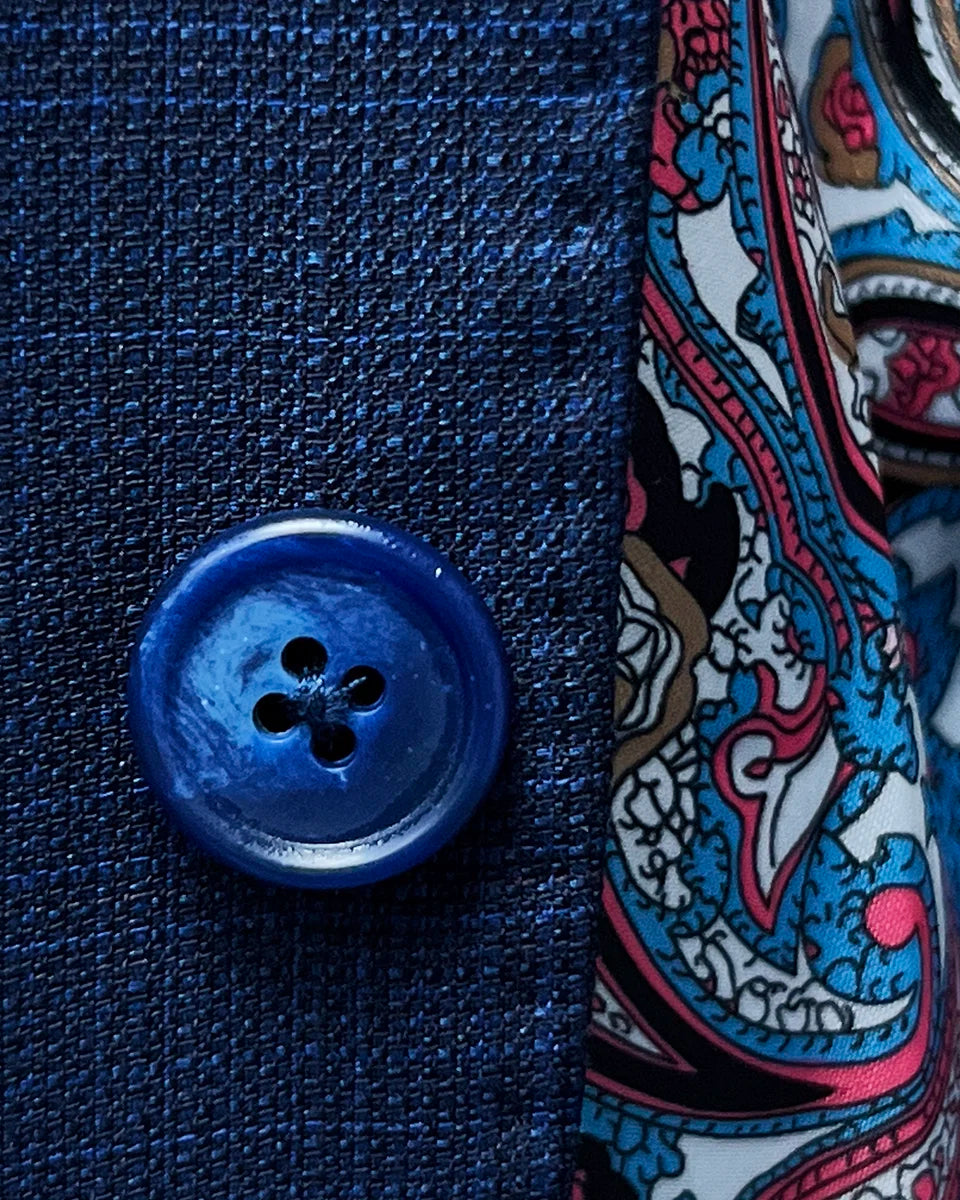 Close-up of the navy marble horn buttons on the royal blue suit jacket.