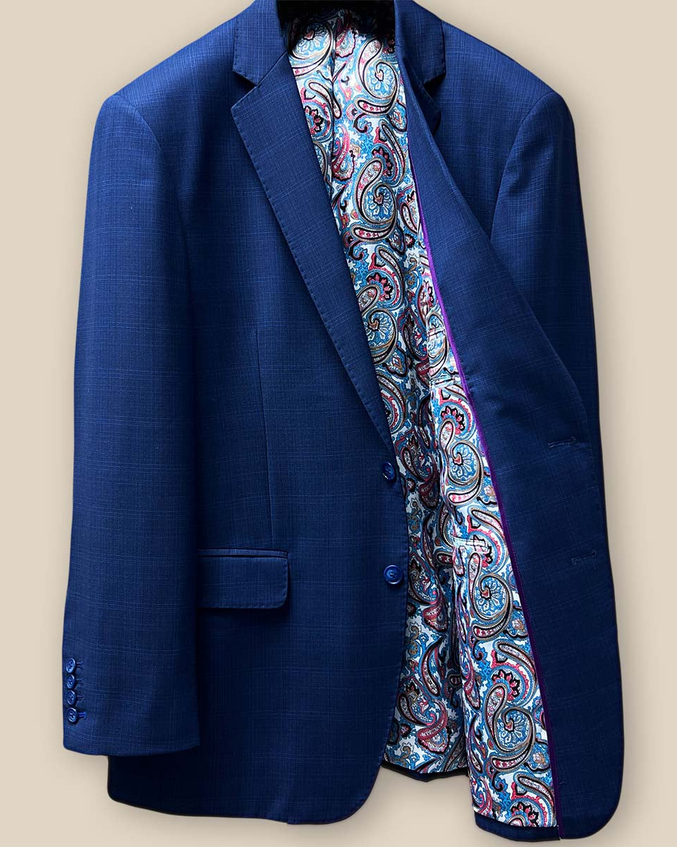 Inside left view of the royal blue suit jacket showcasing the multi-color fancy paisley print lining.