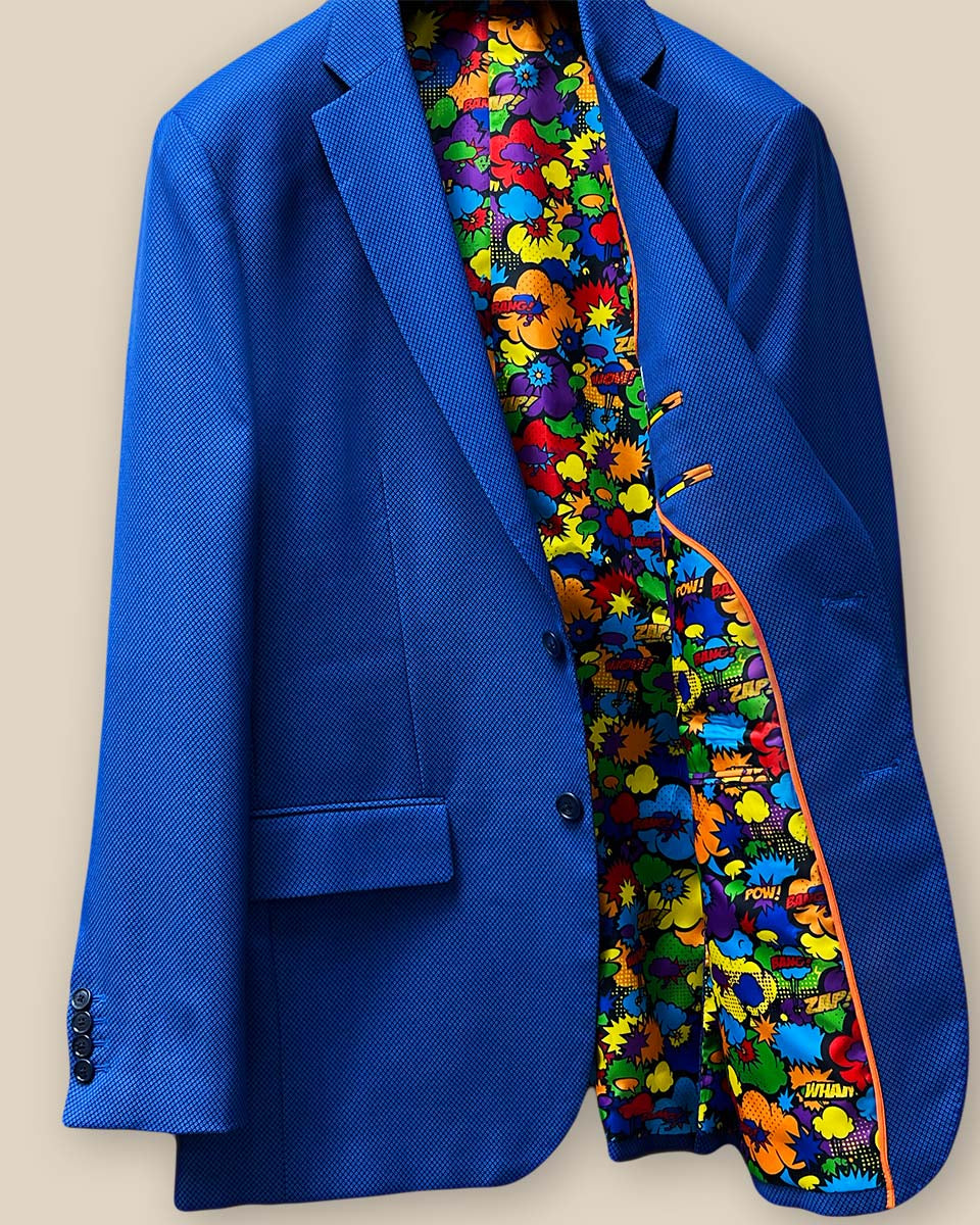 Inside view of the left side of the sapphire blue men's suit, featuring the detailed pocket and colorful lining.