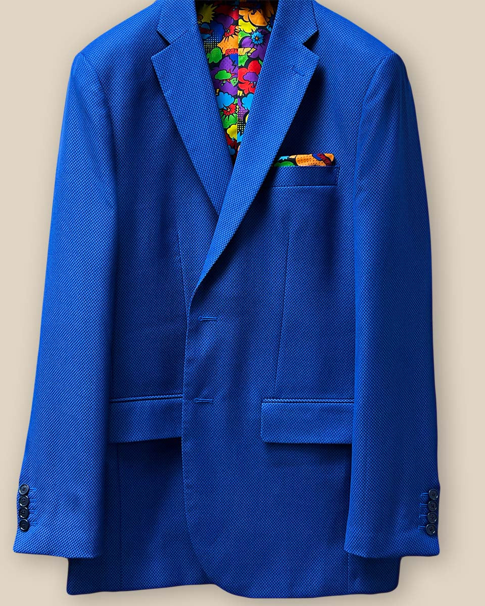 Close-up of the jacket buttonhole panel on the sapphire blue men's suit, showcasing the refined tailoring and contrast details.