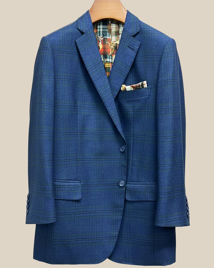 Front button panel of deep blue navy emerald green overcheck suit jacket featuring navy marble horn buttons and hand pick stitching