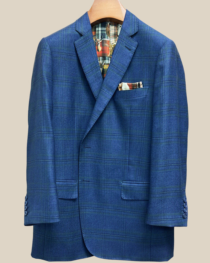Close-up view of deep blue navy emerald green overcheck suit jacket showing contrast navy accent buttonhole with hand-finished stitching detail