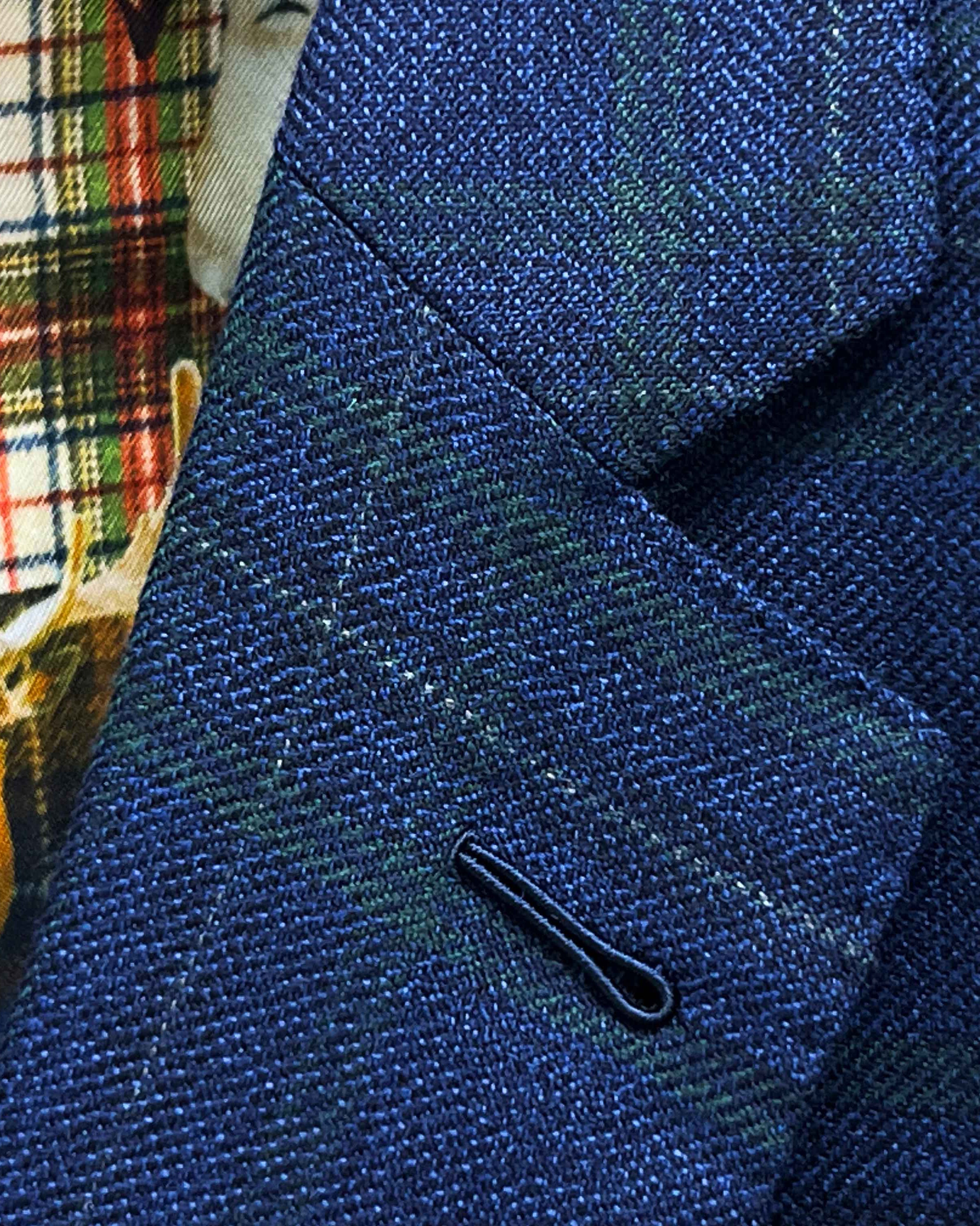Classic notch lapel detail on deep blue navy emerald green overcheck suit jacket showing hand pick stitching and plaid pattern