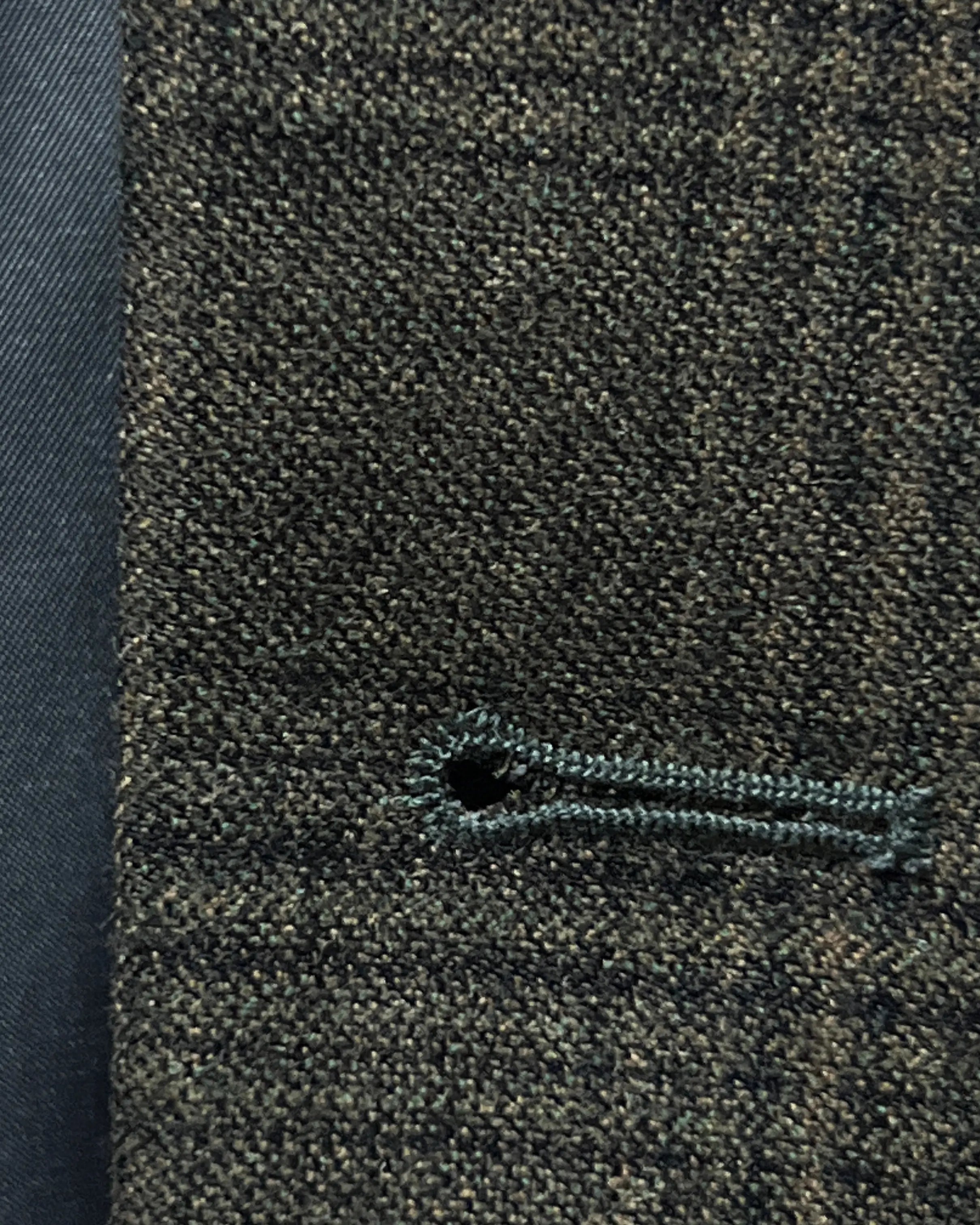 Front buttonhole close up of charcoal brown melange tonal Glen Plaid men's sport coat showing clean tailored buttonhole construction.