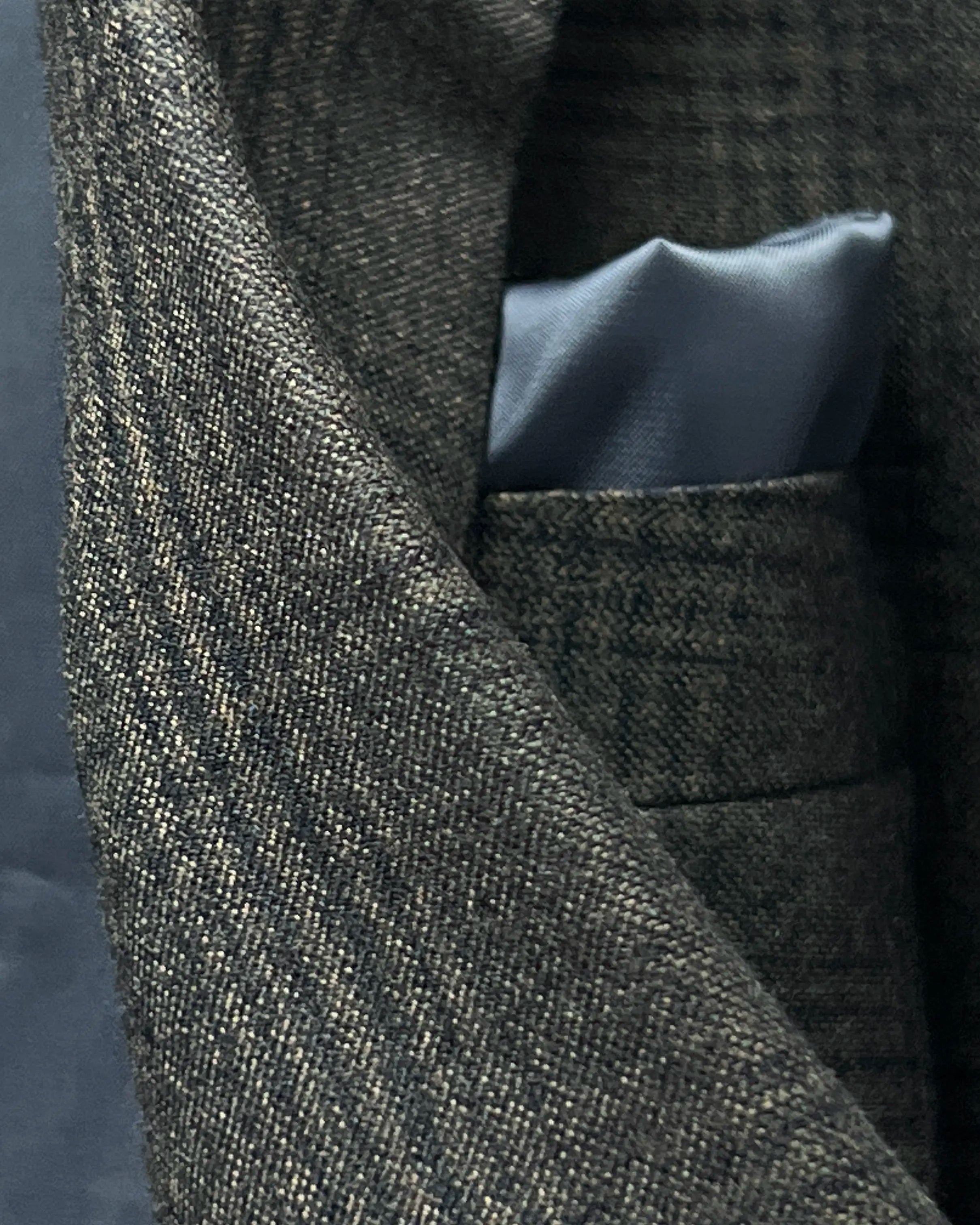 Fabric close up of charcoal brown melange tonal Glen Plaid men's sport coat showing woven texture and fine yarn detail.