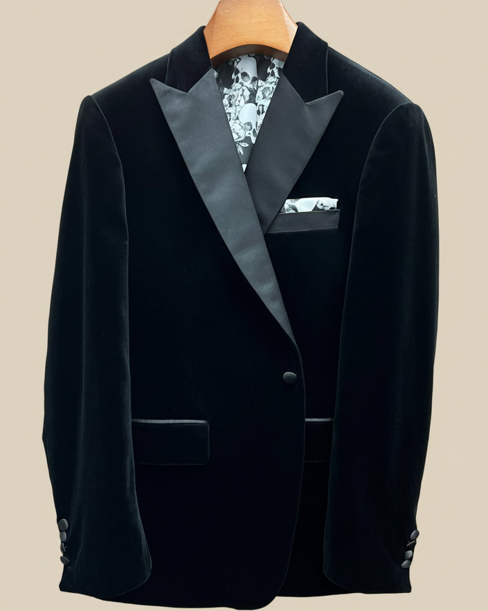 Front button panel of black silk velvet formalwear tuxedo jacket featuring black silk satin covered buttons and hand pick stitching