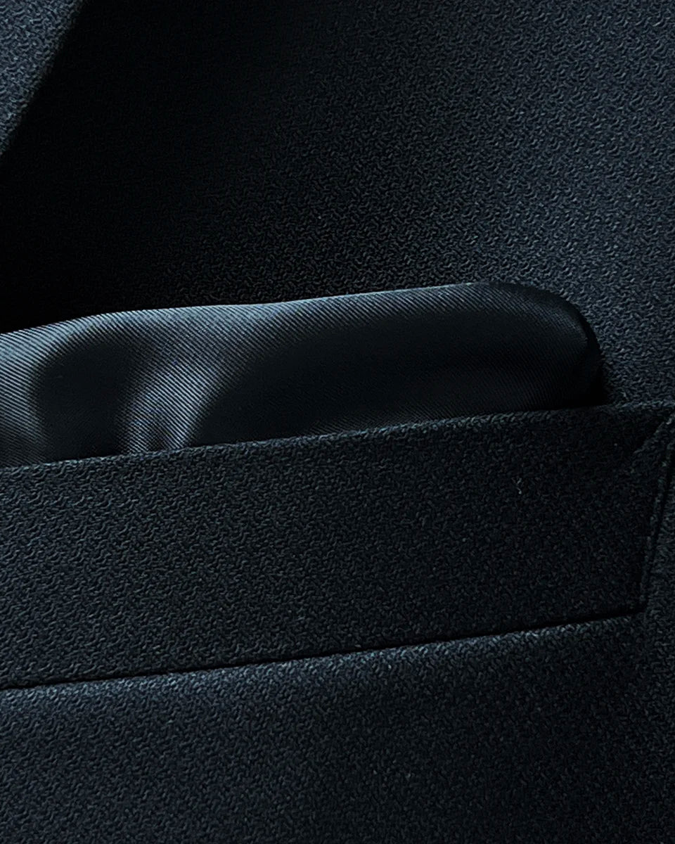 Close-up of a built-in pocket square detail on a black Westwood Hart suit jacket