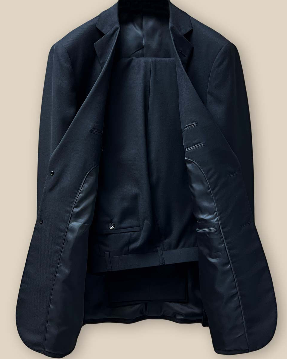 Front view of a two-piece black Westwood Hart suit, showcasing the self-textured jacquard fabric and notch lapel