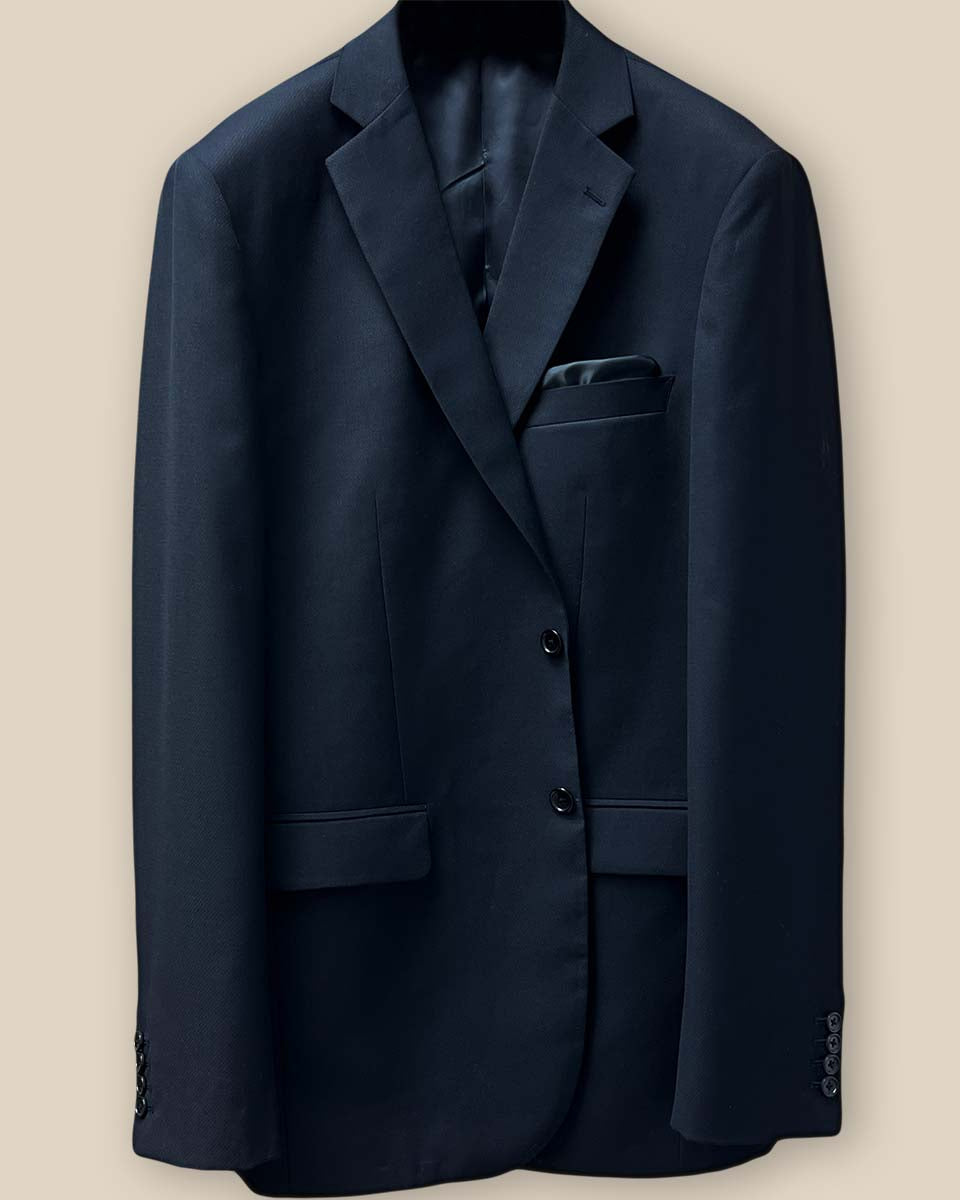 Close-up of the button panel on a black self-textured jacquard suit jacket, featuring black horn buttons