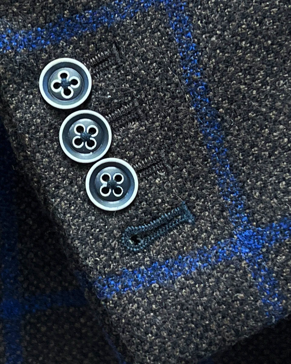 Functional sleeve buttonholes with navy accent buttonhole on the Westwood Hart brown with royal blue windowpane sportcoat.