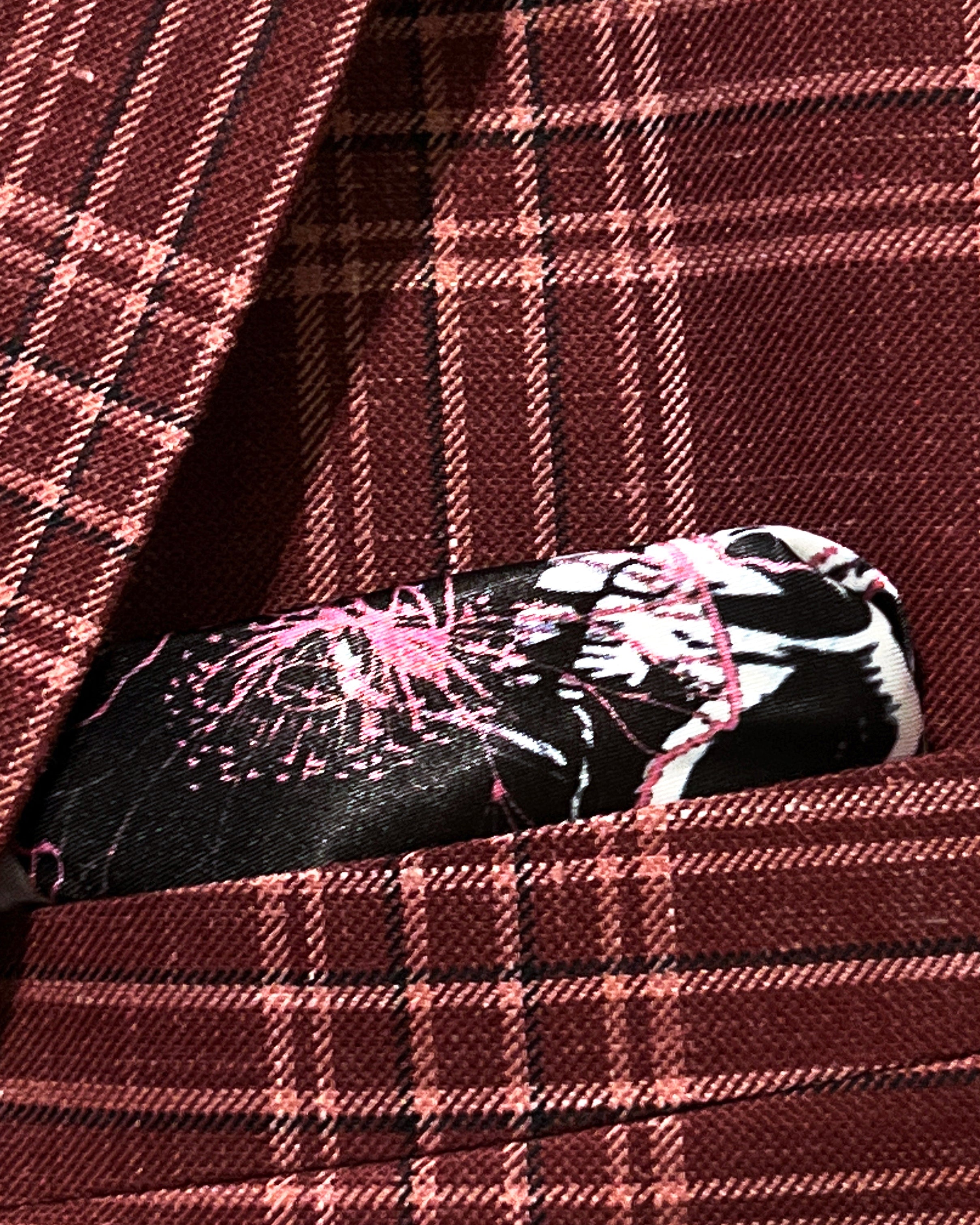 Breast pocket of burgundy plaid sport coat with built-in pocket square holder and hand-finished edges