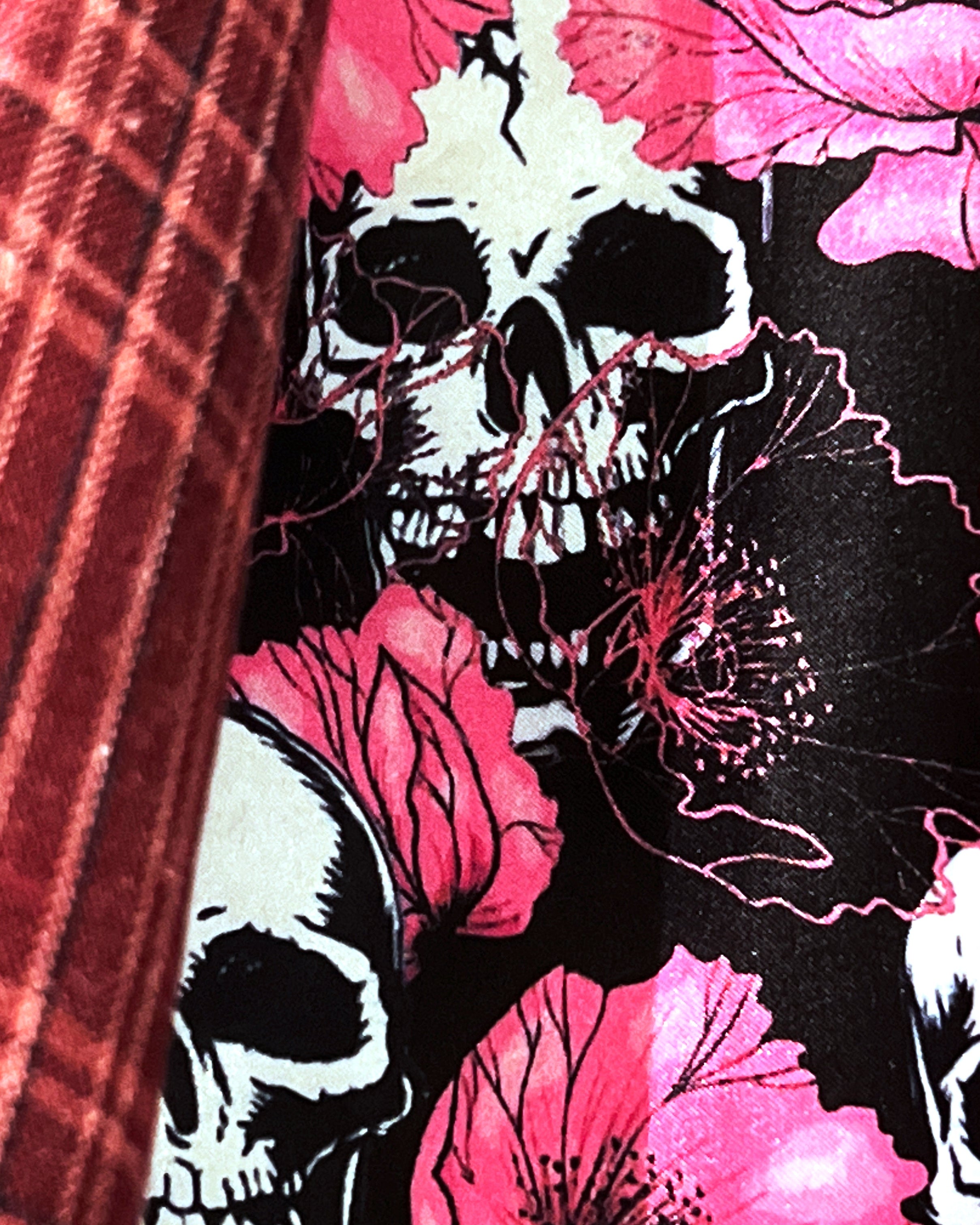 Colorful flash lining detail visible at jacket cuffs and vents in black with pink floral and skulls pattern