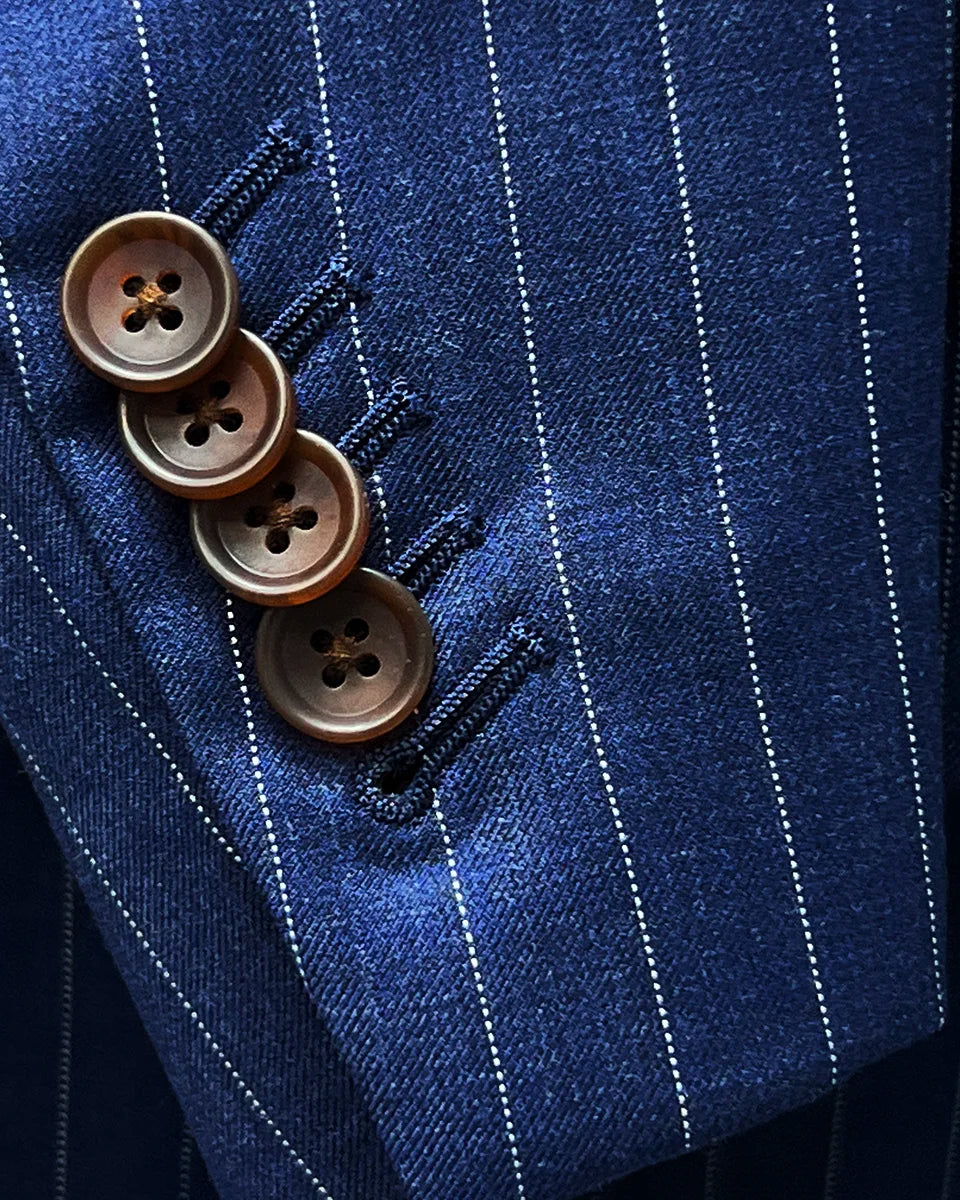 Detail of suit sleeve cuff, showing functional buttonholes with brown horn buttons