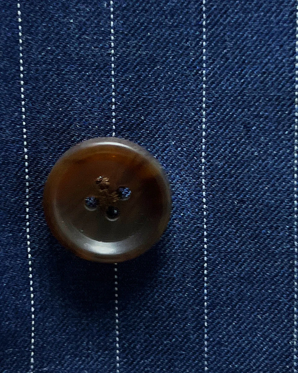Detailed view of brown horn buttons, showcasing their unique marbling
