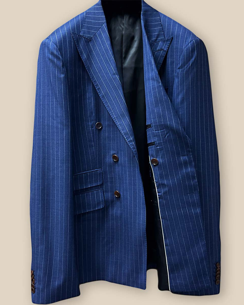 Interior view of suit jacket's left side, showcasing black silk Bemberg lining and inner pockets