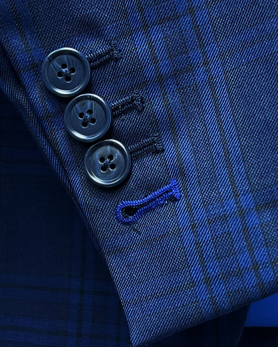 Detail shot of functional buttonholes on suit sleeve, including royal blue accent on last buttonhole