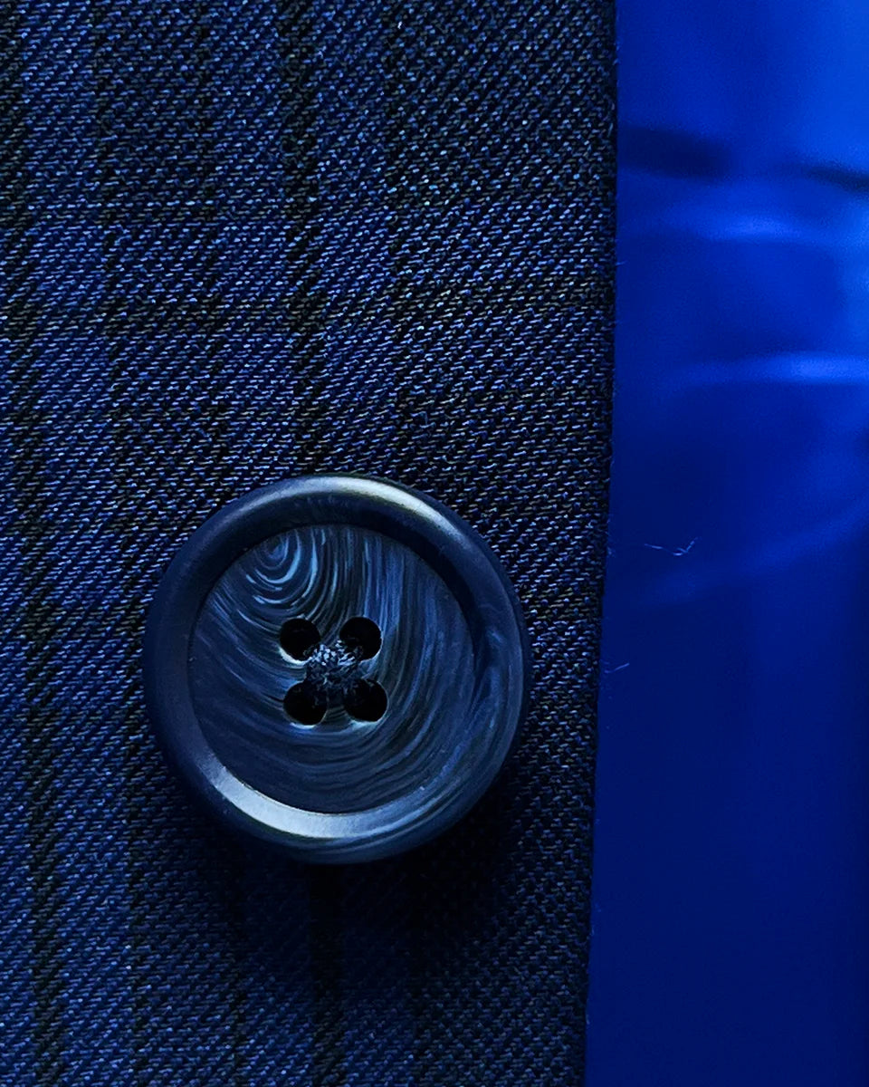 Detailed view of navy horn buttons on dark blue Westwood Hart suit jacket