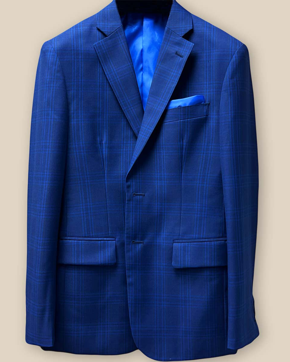 Close-up of dark blue Westwood Hart suit jacket showing windowpane pattern and royal blue accent buttonhole on sleeve