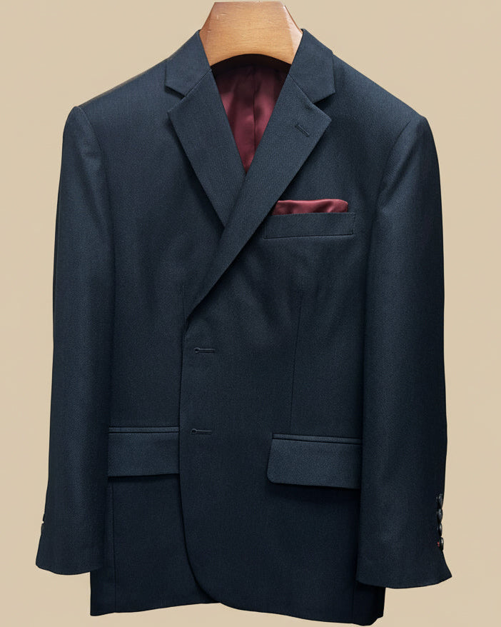 Close-up view of dark charcoal grey birdseye suit jacket showing contrast deep burgundy accent buttonhole with hand-finished stitching detail