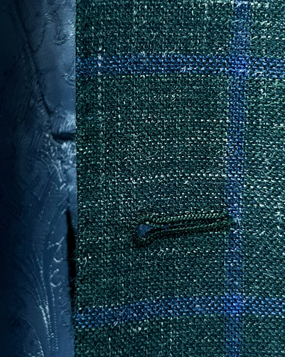 Macro shot of buttonhole stitching on dark green Westwood Hart windowpane sport coat, showcasing precision and craftsmanship