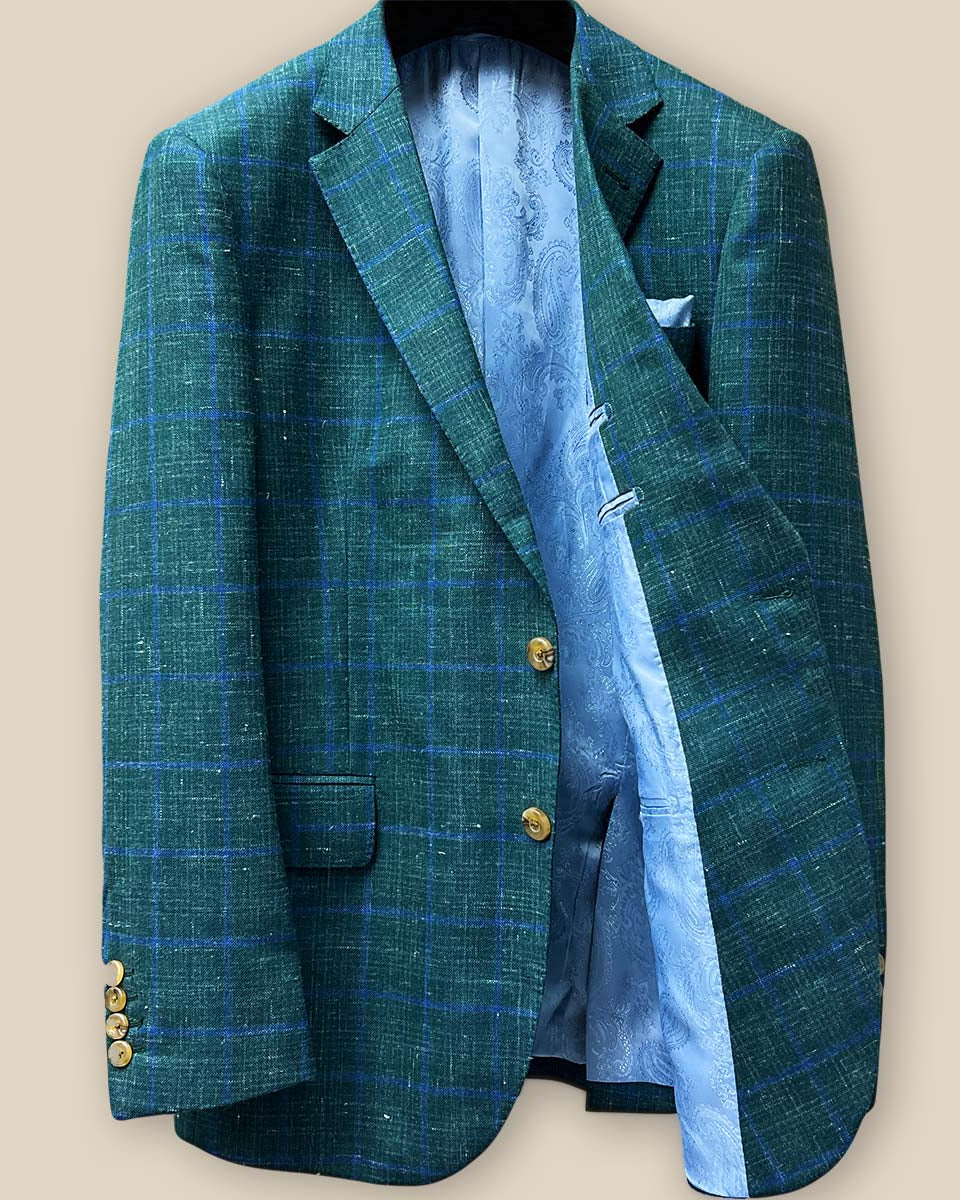 Interior view of dark green Westwood Hart windowpane sport coat, left side, revealing sky blue paisley lining and inner pockets