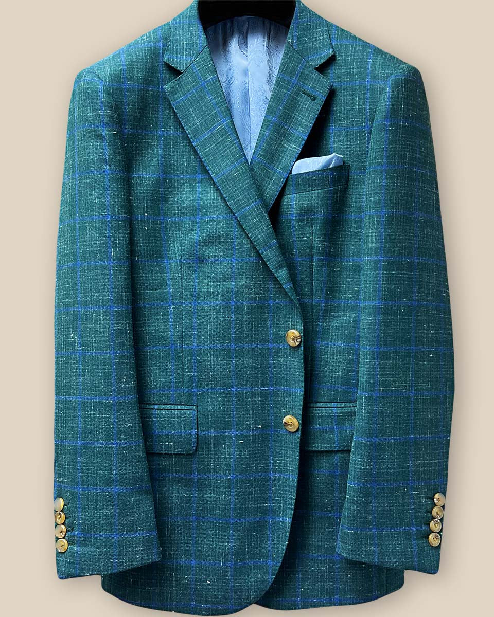 Close-up of button panel on dark green Westwood Hart windowpane sport coat, featuring tan horn marble buttons and matching stitching